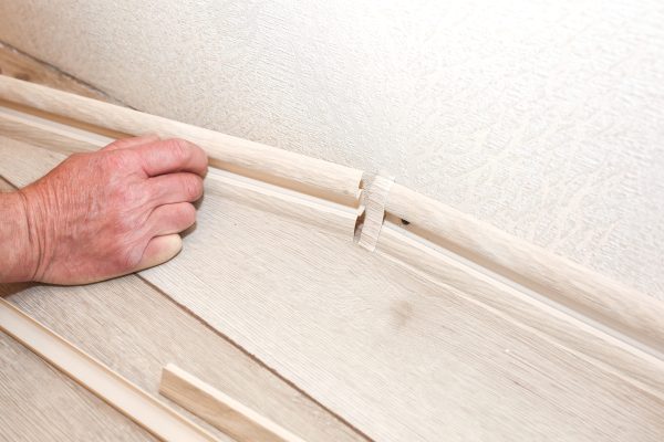 man-is-installing-the-baseboard-repair-works-indo-2025-10-14-07-21-33-utc (1)